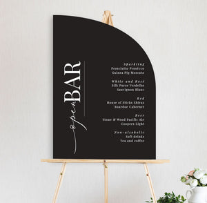 open bar sign black and white half arch on easel