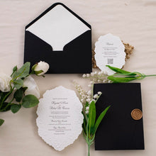 A white scalloped wedding invitation suite with floral embossed detailing and black printed text in a beautiful shape, matching black envelope with embossed envelope liner and gold wax seal