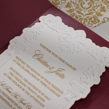 Embossed sculptured wedding invitation featuring roman column design closeup and shown with burgundy velvet pocket