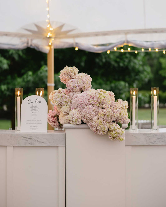 Wedding Bar Sign with 'Cin Cin' amoré design, candles, and hydrangea flowers.