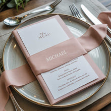 Wedding reception menu with a pink ribbon with guest name on a plate