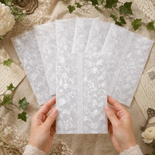 floral vine vellum wrap jacket printed in white ink on transparent paper group with hands holding