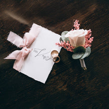 deluxe vow booklet with pink chiffon ribbon and printed on indi handmade deckle edge paper