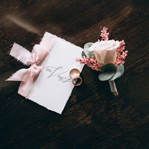 deluxe vow booklet with pink chiffon ribbon and printed on indi handmade deckle edge paper