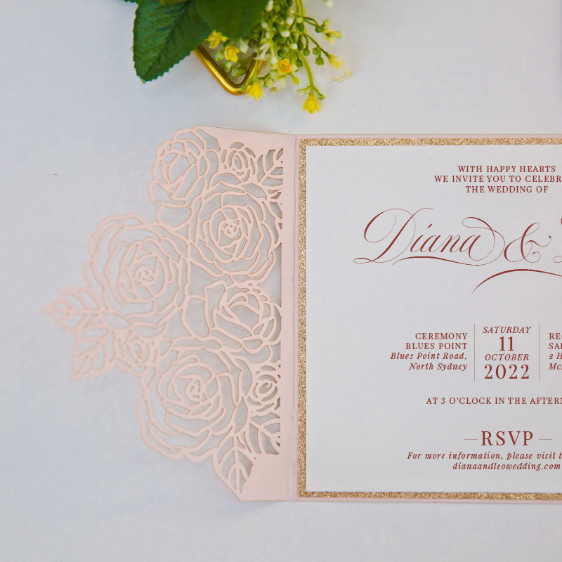 Elegant laser-cut wedding invitation with floral rose design open