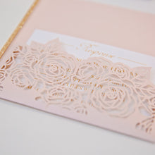 Elegant laser-cut wedding invitation with floral rose design detail pocket
