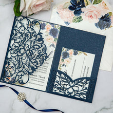 Navy blue laser-cut invitation card with a swirl patterned design featuring blue floral wedding invitation 