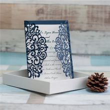 Gate-fold laser-cut wedding invitation featuring a swirl design in navy