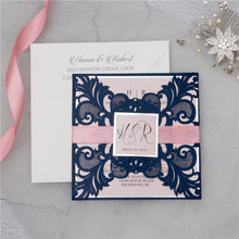 Laser-cut Gate Fold Wedding Invitation with swirl in navy with silver foil backing card, belly band & tag and pink ribbon