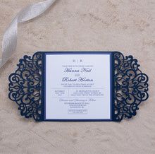 Gate-fold laser-cut square wedding invitation featuring a swirl design in navy