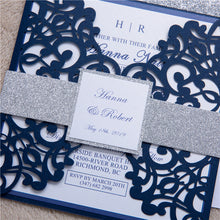 Gate-fold laser-cut square dding invitation featuring a swirl design in burgundy with a silver glitter belly band