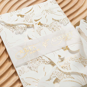 floral lily laser-cut invitation with gold foil belly band
