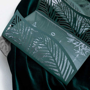 green palm leaves laser-cut invitation closeup