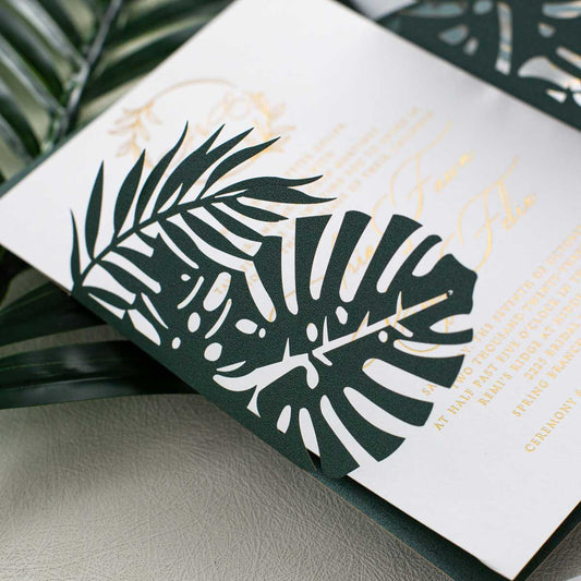 green monstera leaves laser-cut invitation closeup