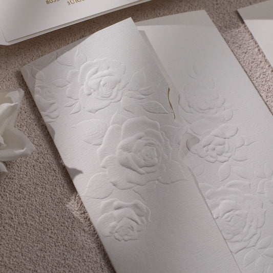 Sculptured embossed rose designed gate-fold wedding invitation, closed