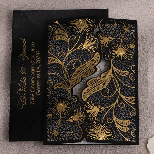 Black Laser-cut gate-fold invitation featuring anemone design with gold foil highlights closed