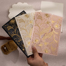 Group of Laser-cut gate-fold invitation featuring anemone design with gold foil highlights pink, white and black