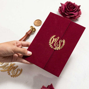 gold acrylic wreath intials on red velvet invitation