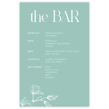 A printed bar menu card titled "the BAR" with white magnolia flower design