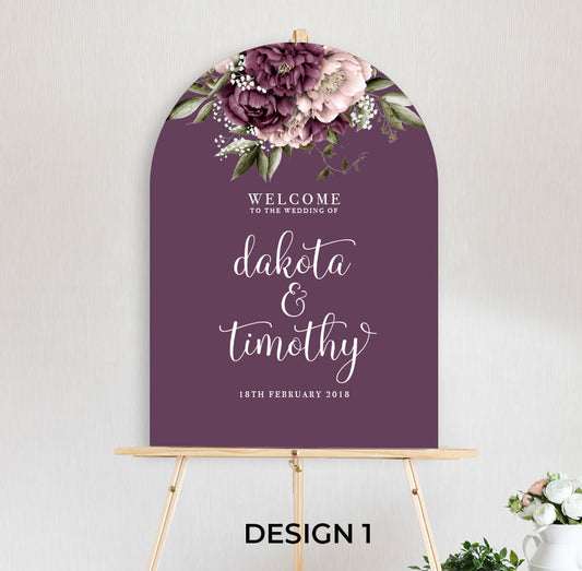 beautiful floral welcome sign Blushing Marsala Peonie featuring burgundy and dusty pink peonie florals in an arch shape sitting on timber easel