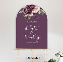 beautiful floral welcome sign Blushing Marsala Peonie featuring burgundy and dusty pink peonie florals in an arch shape sitting on timber easel
