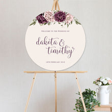 beautiful floral welcome sign Blushing Marsala Peonie featuring burgundy and dusty pink peonie florals in a circle shape sitting on timber easel
