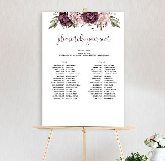 Blushing Marsala Peonie table seating chart featuring burgundy and dusty pink peonie flowers at the top of the sign, sitting on a wooden easel