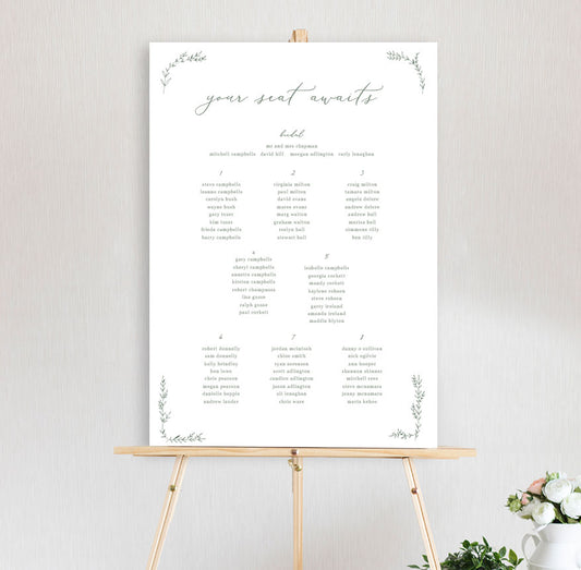 botanical beth wedding table seating chart featuring leaf design and handdrawn font script on an easel