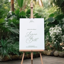 botanical beth wedding welcome sign featuring leaf design and handdrawn font script on an easel in a garden setting