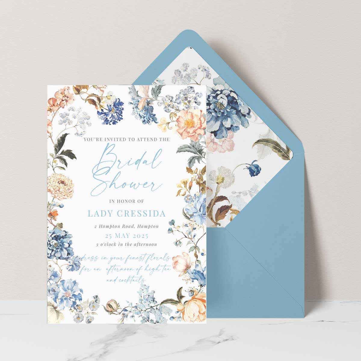 Bridgerton insppired bridal shower invitation with peach and blue florals in a frame blue envelope