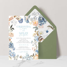Bridgerton Lake vintage inspired floral wedding invitation featuring blue and peach flowers framing the design with green coloured envelopes and floral liner
