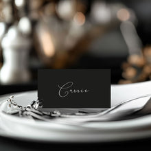 Classic, modern, minalist design Place card with 'Carrie' on a table setting with silverware and a blurred background