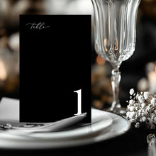 Classic black and white Table number card with a wine glass, plate and babys breath at wedding reception