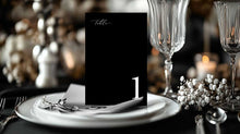 Classic black and white Table number card with a wine glass, plate and babys breath at wedding reception
