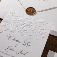 Wedding Invitation card with floral sculptured embossing and wax seal on a white envelope