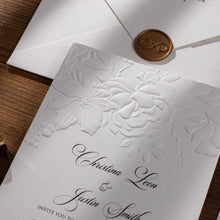 Wedding Invitation card with floral sculptured embossing and wax seal on a white envelope