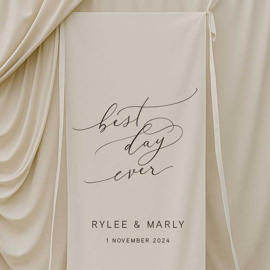 fabric wedding welcome sign featuring words best day ever and couple name and date