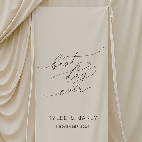 fabric wedding welcome sign featuring words best day ever and couple name and date