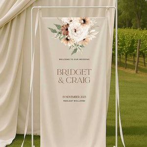 Wedding welcome sign with bohemian floral design and text in an outdoor setting