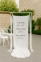 i have found the one whom my soul loves white fabric linen welcome sign an outdoor setting with chairs and a stone wall.