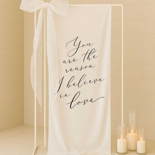 white linen fabric welding sign with saying you are the reason I believe in love