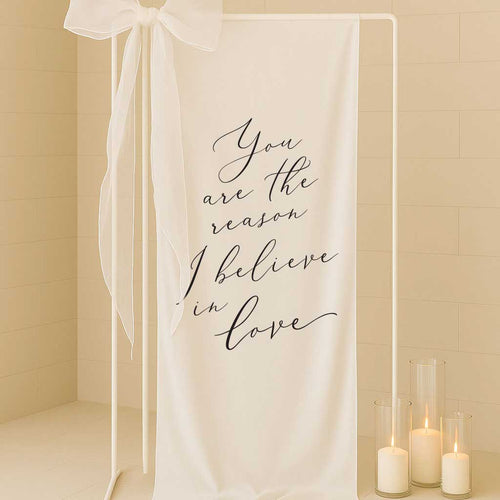 white linen fabric welding sign with saying you are the reason I believe in love
