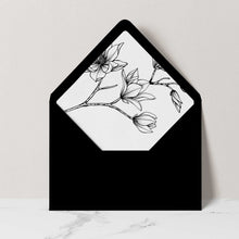 A black envelope with a matching floral liner featuring white line art of magnolia blossoms.
