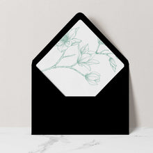 A black envelope featuring a delicate sage  green magnolia floral line drawing.