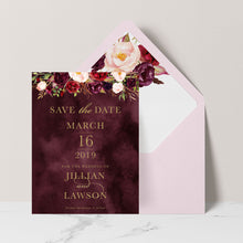 Marsala Flowers Save the Date card with floral design and gold text on a burgundy background with pink envelope and matching floral liner