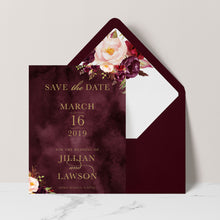 Marsala Flowers Save the Date card with peonie floral design and gold text on a burgundy background with burgundy envelope and matching floral liner