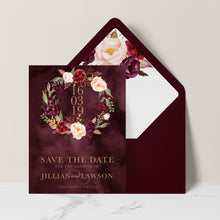 Marsala Flowers Save the Date card with peonie floral wreath design and gold text  on a burgundy background with burgundy envelope and matching floral liner