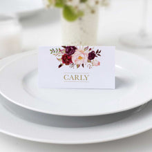 Marsala Flowers Collection, place card with white looking background, the design features lush hand-painted florals in shades of blush, ivory, and burgundy wine, creating a soft yet dramatic contrast. Elegant gold typography adds a touch of luxury, beautifully complementing the warm tones and enhancing the overall sophistication of the piece.