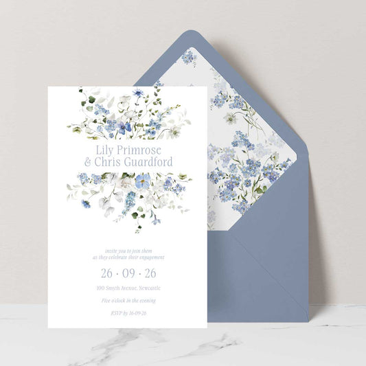 Primrose Spring is a romantic floral engagement invitation suite featuring white and blue florals set with a dusty blue envelope and matching liner