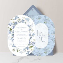Primrose Spring Wedding Invitation suite in an oval shape, double-sided with linitials, hand-painted botanicals in powder blue, soft white and fresh green gently frame the invitation, featuring a dusty blue envelope with matching floral liner